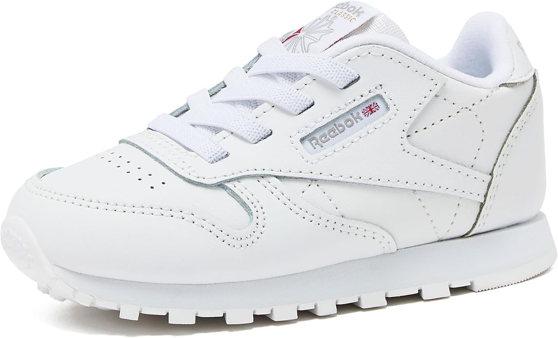 White leather kids low-top lace-up sneakers with a white rubber sole.