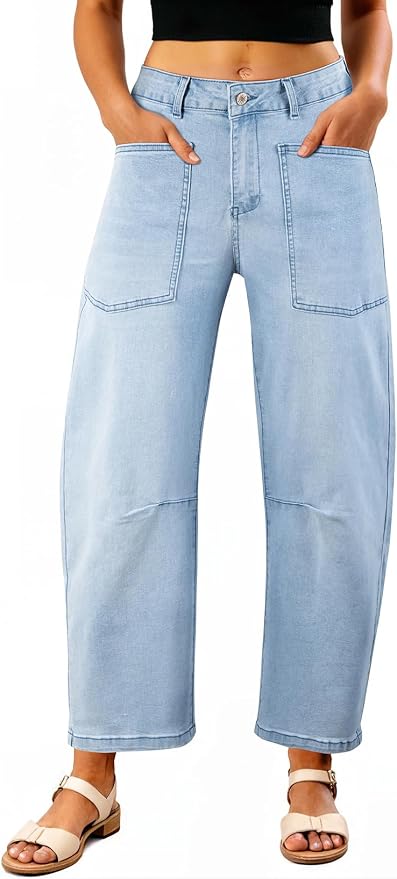 Woman wearing light wash barrel leg jeans with front patch pockets.