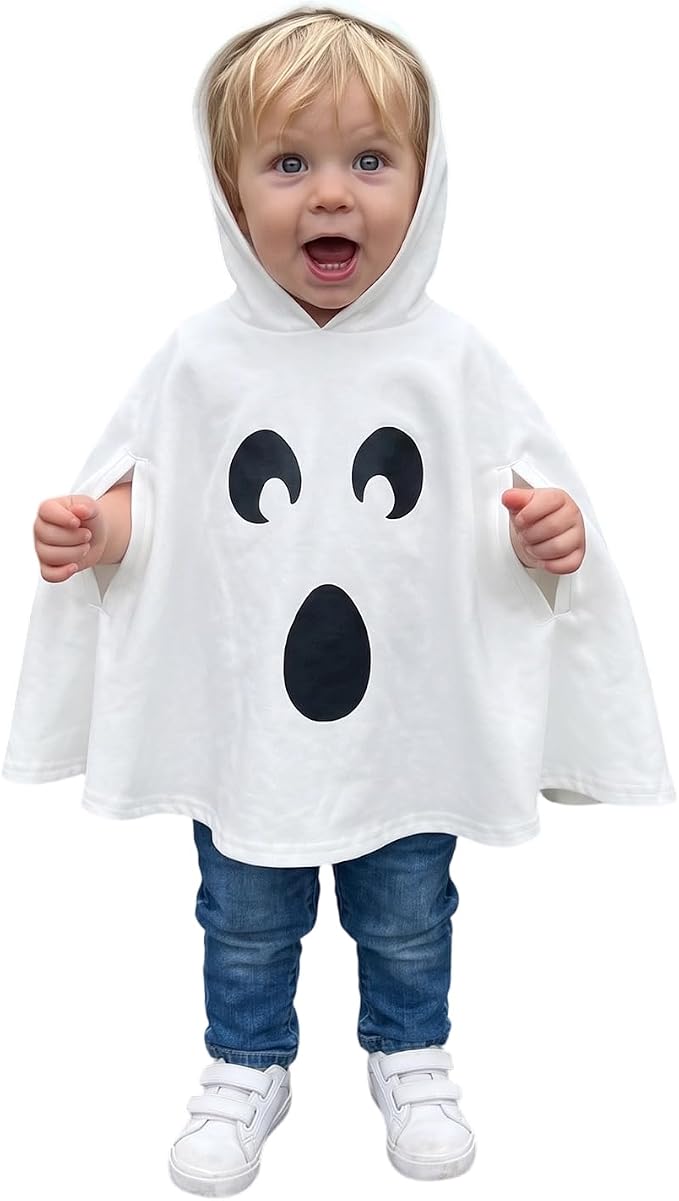Toddler wearing a white hooded ghost cape with a black ghost face on the front.