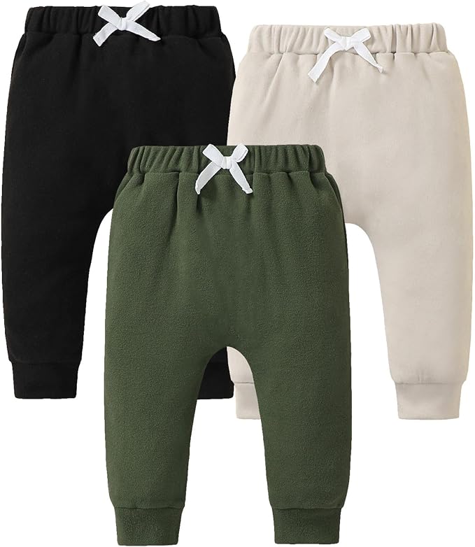 Three pairs of toddler fleece joggers in black, olive green, and cream with drawstring waists.