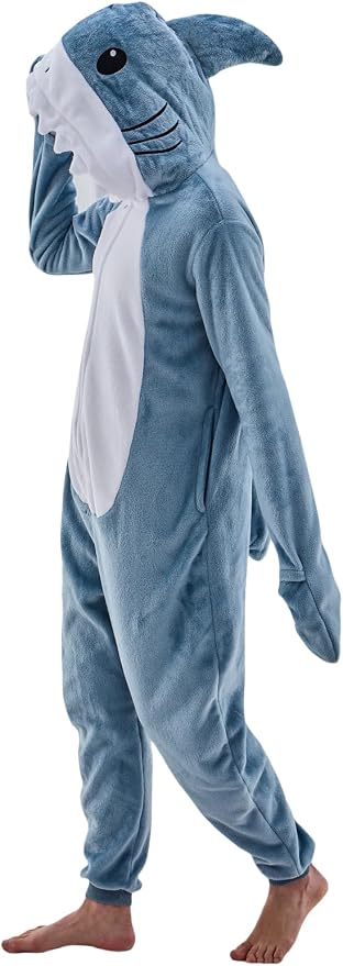 Adult wearing a grey-blue plush shark onesie with a hood, fin, and toothy mouth.