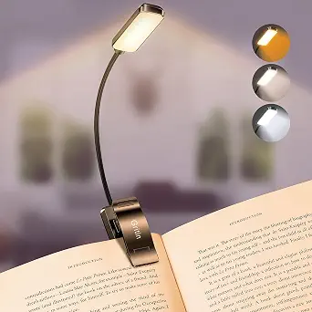 Gritin clip-on rechargeable LED book light attached to an open book, with warm and cool light settings shown.