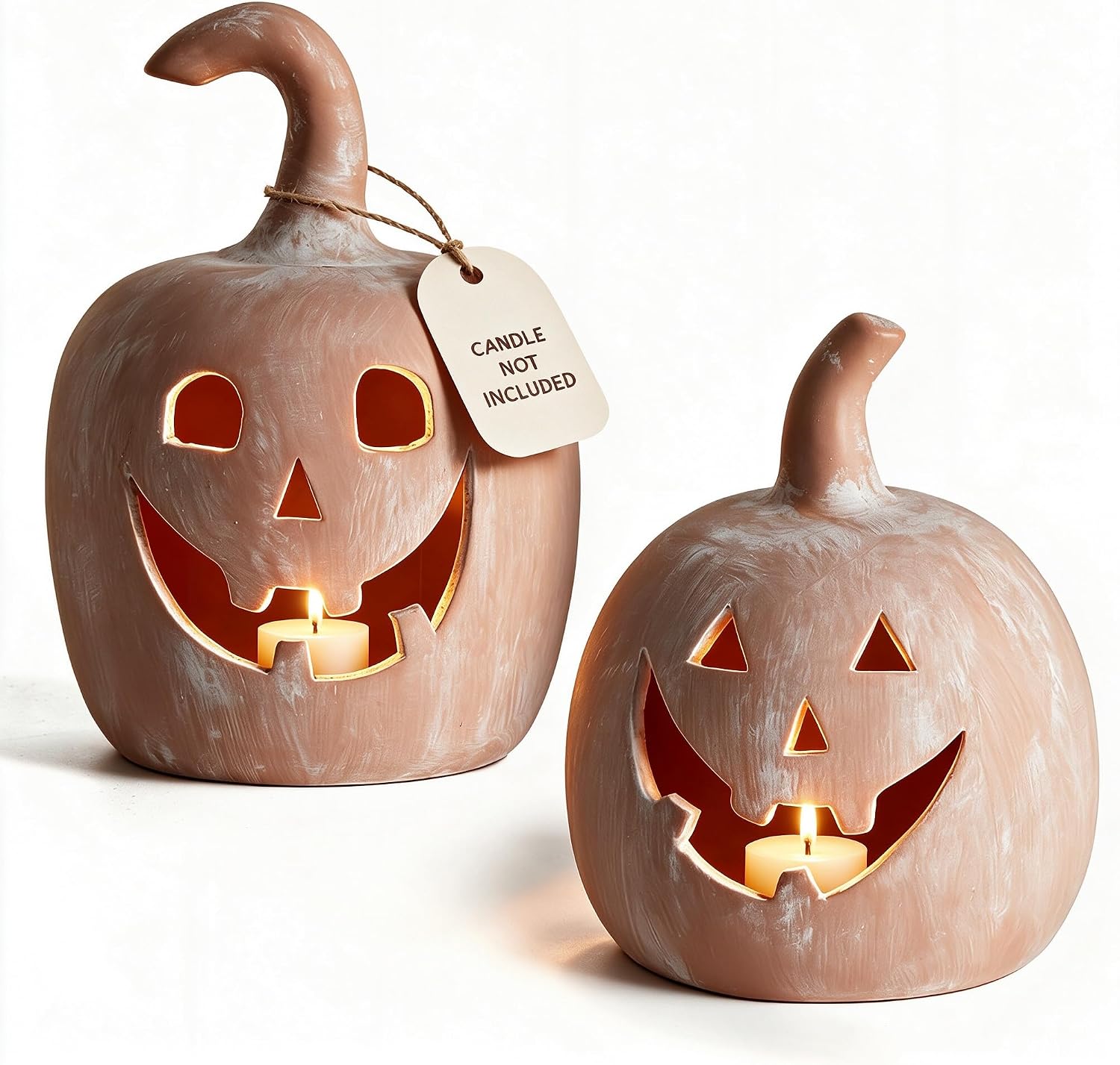 Two terracotta pumpkin tealight holders with carved jack-o'-lantern faces and lit candles.