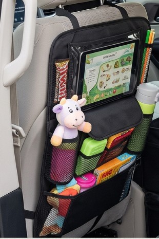 Black backseat car organizer hanging over the front seat with a tablet holder, snacks, and a stuffed toy in the pockets.