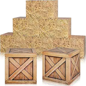 Stack of small decorative hay bales next to two wooden crate props.