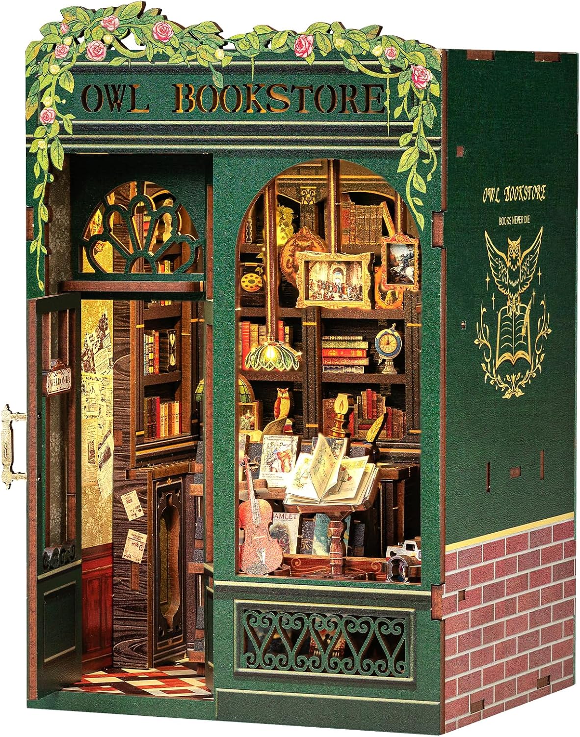 Green Owl Bookstore book nook with tiny lit shelves of books and climbing roses on top.