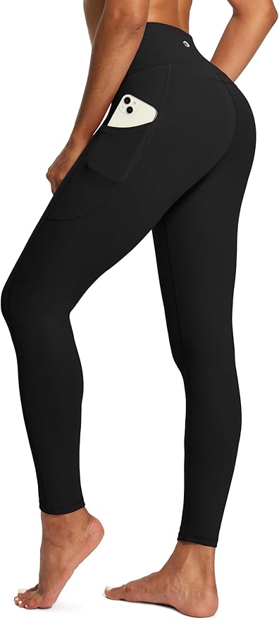 Black high waisted tummy control leggings with a side pocket holding a phone.