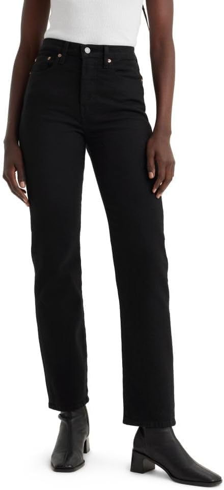 High-waisted black straight leg jeans worn with black heeled boots.
