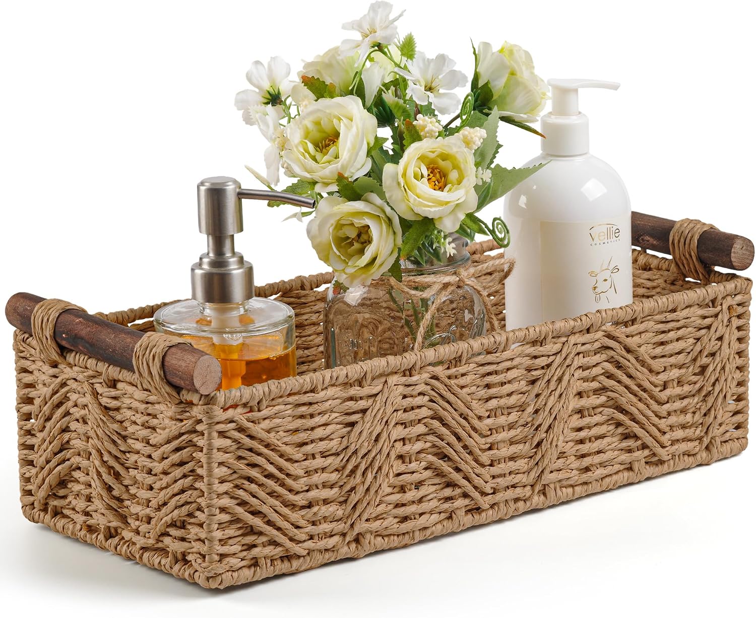 Woven natural rope storage basket with wooden handles holding a soap pump and flowers.