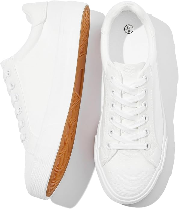 Pair of white low top canvas sneakers with white laces and a gum sole.