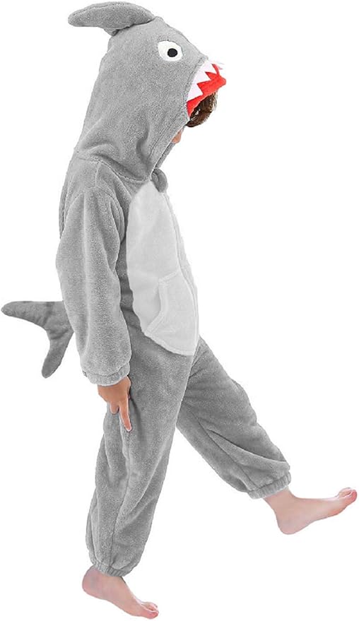 Child wearing a grey shark jumpsuit with a tail, fin hood, and red mouth detail.