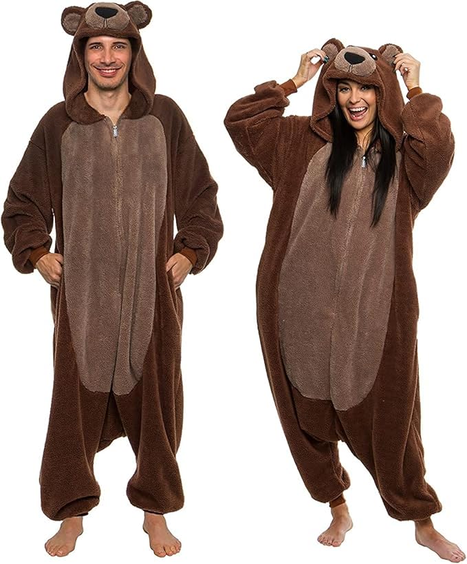 Two adults wearing brown sherpa bear onesies with hoods and bear faces.